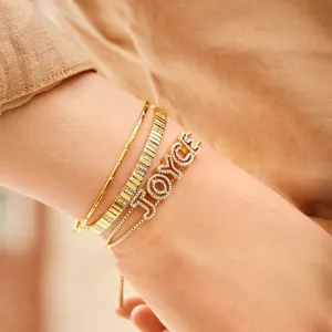 Custom gold brass pavé zircon letter name bracelet stack, stylish layered design.