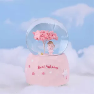Pink snow globe crystal ball music box with cute angel girl for romantic holiday gift.