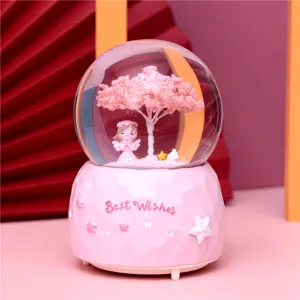 Pink crystal snow globe with angel girl and music box base for romantic bedroom decor and gifts.