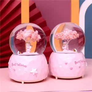 Cute pink snow globe night light with angel and cherry tree figure, romantic Valentine gift.