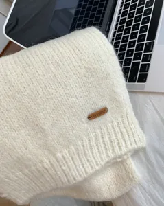 Gemütlicher Strickschal mit Alpakawolle Detailansicht, weicher Winterschal mit Lederetikett.