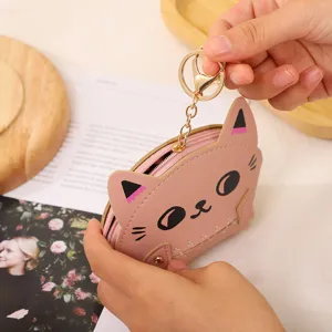 Cute pink cat coin purse with keychain, mini leather zipper wallet and earphone bag detail.