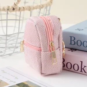 Pink mini backpack coin purse detail, shiny sequin finish, cute zipper pouch close-up.