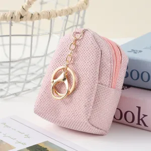 Pink glitter mini backpack keychain, cute zipper coin purse and headphone storage pendant.