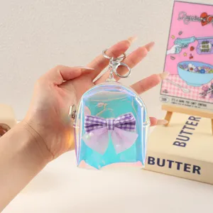 Mini holographic backpack coin purse detail shot, featuring a purple plaid bow and keychain.