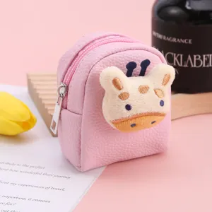 Close-up view of the cute pink mini backpack coin purse featuring a fluffy giraffe detail.
