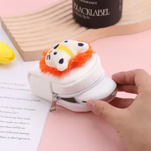 Close-up of cute mini animal coin purse plush pendant zipper detail lifestyle shot.
