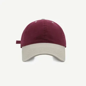 Vista detallada de la gorra de béisbol bicolor con corona suave, cuerpo burdeos y visera beige.