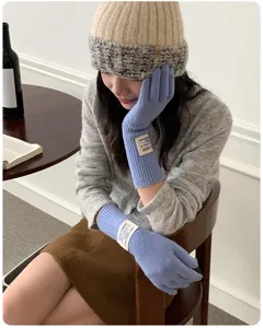 Detail shot of blue knitted long gloves and warm beanie hat, perfect for winter style.