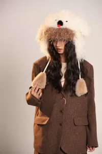 Joli bonnet moelleux chien avec cache-oreilles et blazer marron détail, mode hiver.