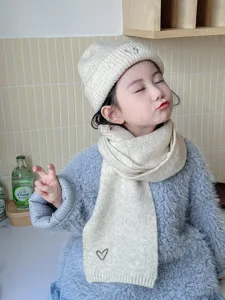 Children's knitted beanie and scarf set in cream white with cute heart embroidery for winter.