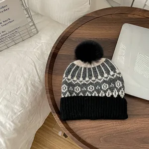 Winter warm knit beanie hat with fluffy pom pom, retro nordic pattern fashion headwear.
