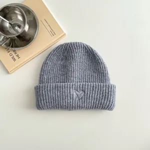 Detailed close-up view of a cozy grey children's knit beanie hat with cute heart embroidery.