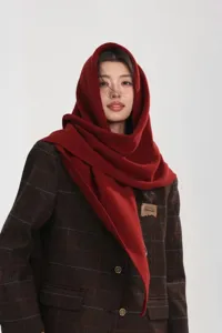 Detail view of a cozy wine red wool triangular scarf shawl, perfect for autumn and winter.