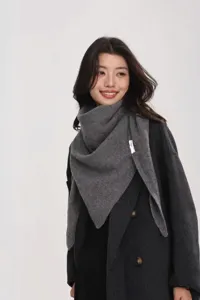 Detailed view of the cozy grey wool triangular scarf shawl elegantly styled on the model.