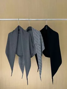 Classic knit triangular scarf shawl detail, cozy winter outerwear accessory in multi colors.