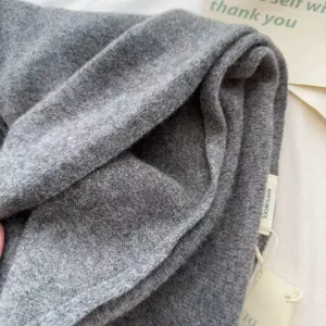Close-up detail of pure wool knitted scarf texture, soft and warm winter accessory.