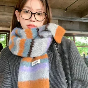 Detailed view of women wool blend colorful striped scarf with cozy texture and stylish design.
