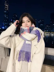 Close-up detail of women winter gradient plaid tassel scarf, soft cashmere-feel warm fabric.