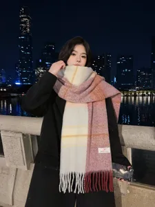 Detailed view of women's color-block gradient tassel scarf, winter cozy cashmere feel.