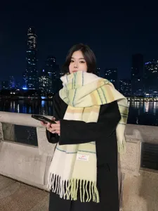 Winter women's color-block plaid imitation cashmere scarf with warm tassels for stylish daily wear.