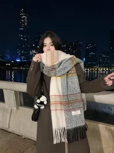 Detailed shot showing the soft texture and gradient color-block design of the warm winter scarf.