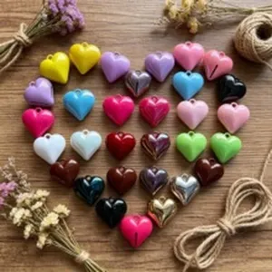 Multicolor heart pendants for DIY jewelry making on wooden background