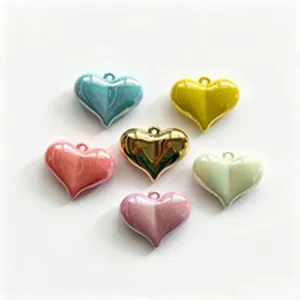 Detailed macro view of colorful heart-shaped CCB electroplated pendants for DIY jewelry making.