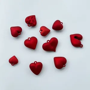 Macro view of multiple red matte heart charms for handmade DIY jewelry making projects