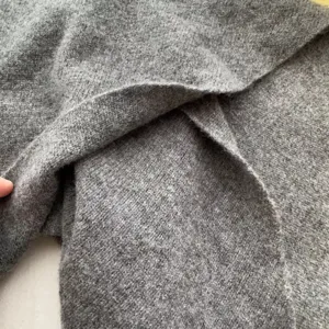 Grey wool triangle scarf knit texture detail close-up warm soft winter shawl wrap