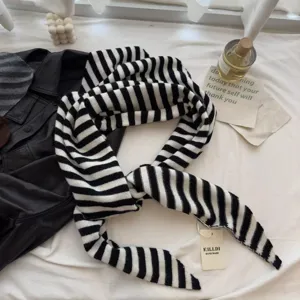 Classic black and white striped knitted scarf, warm and stylish winter accessory.
