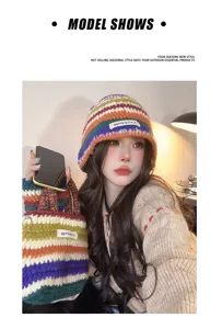 Close-up detail shot of the colorful knitted beanie hat and matching bag in cozy winter style.