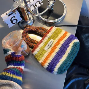 Stylish autumn winter handmade crochet rainbow handbag and knitted gloves set, vibrant design.