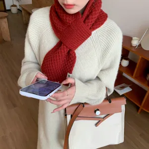 Detailaufnahme des roten Strickhalstuchs am Model, gemütlicher Winterstil und Design.
