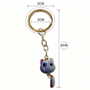 Cute cat keychain detail view showing metal ring and charming gradient pendant with size marks.