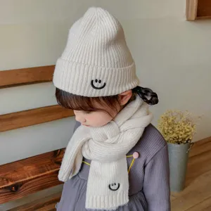 Kids winter warm knitted hat and scarf set with cute smiley face embroidery in solid color.