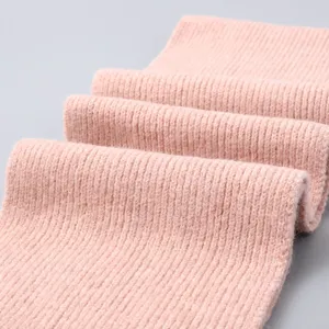 Pink ribbed knit scarf detail texture closeup showing soft warm winter material.