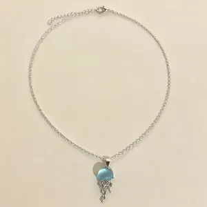 Delicate silver jellyfish pendant necklace, sweet ocean style summer beach jewelry accessory.