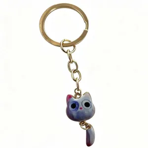 Cute milky purple big-eyed cat keychain with golden chain and movable tail design for daily wear