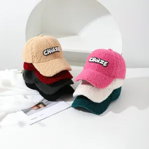 Cozy teddy shearling baseball cap for women, soft plush winter hat with chic letter embroidery.