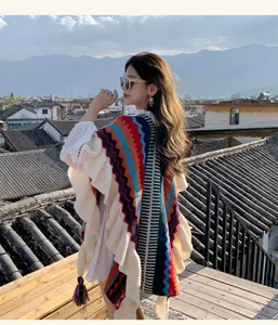 Bohemian rainbow knit poncho with lettuce trim, stylish travel cape for women daily wear.