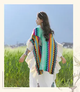 Bohemian colorful striped knitted poncho with ruffled edges, perfect for outdoor travel.