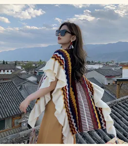 Detailed view of bohemian style knit ruffle split shawl, colorful rainbow stripe cape.
