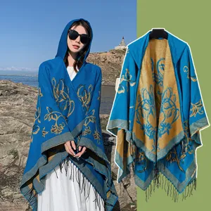 Ethnic hooded split cape shawl, blue and gold reversible warm tassel poncho for travel.