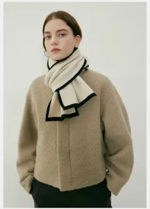 Primo piano dettaglio della sciarpa lavorata a maglia bicolore autunno inverno donna calda.