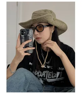 Retro outdoor bucket hat with adjustable chin strap, stylish sun protection for hiking.