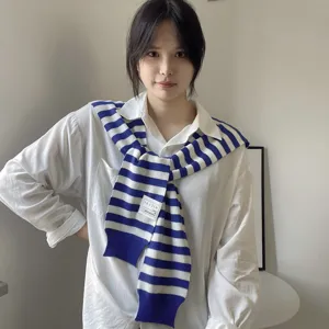 Stylish blue and white striped knit shawl for women, perfect autumn layering accessory over shirts.