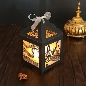 Boîte lanterne en papier avec notes de musique ruban blanc et lumière LED chaleureuse.