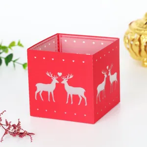 Red laser-cut paper candle shade with cute deer design, perfect for Christmas home decor lighting.