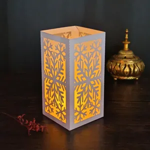Christmas snowflake paper lamp detail, laser cut hollow candle holder cozy night light glow view.